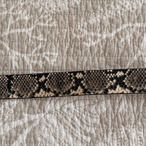 Women's Genuine Snake Leather (upper) belt with decorative metal buckle.